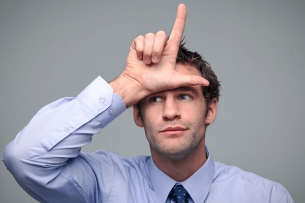 business man putting hand on forehead with loser gesture