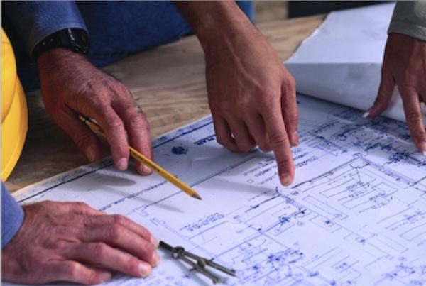 hands working on blueprints