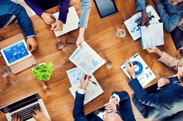 aerial view looking down on business professionals working around conference table