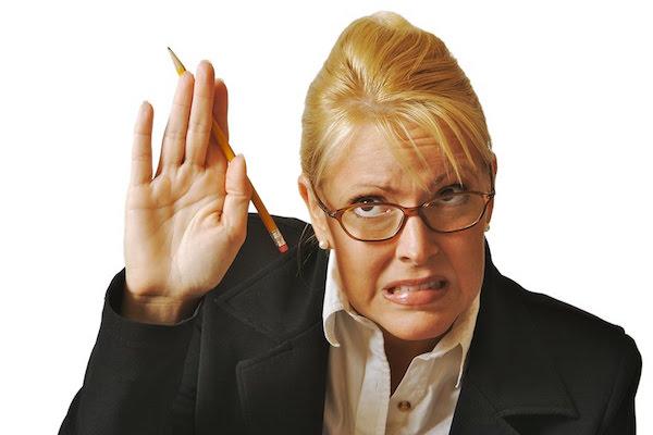 timid woman in business suit raises her hand fearfully with terror on her face
