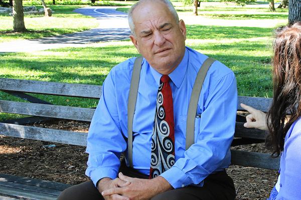 business man on park bench talking with woman