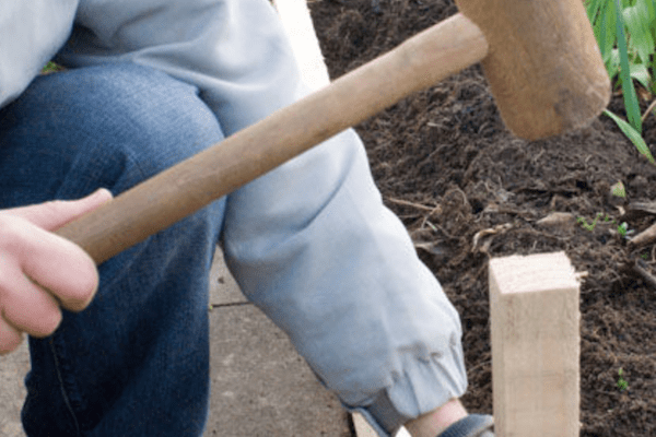 hammering a stake in the ground