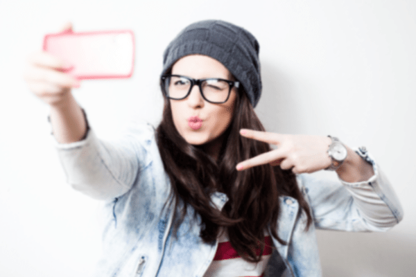 young person taking a selfie with phone