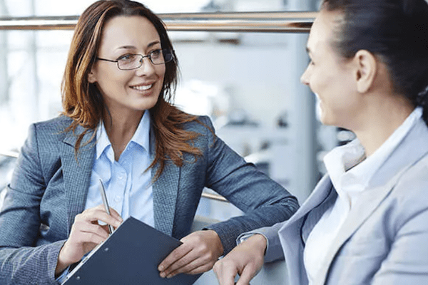 Two business women in a relaxed conversation