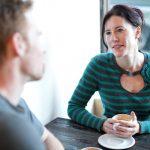 Woman and man talking over coffee at a cafe