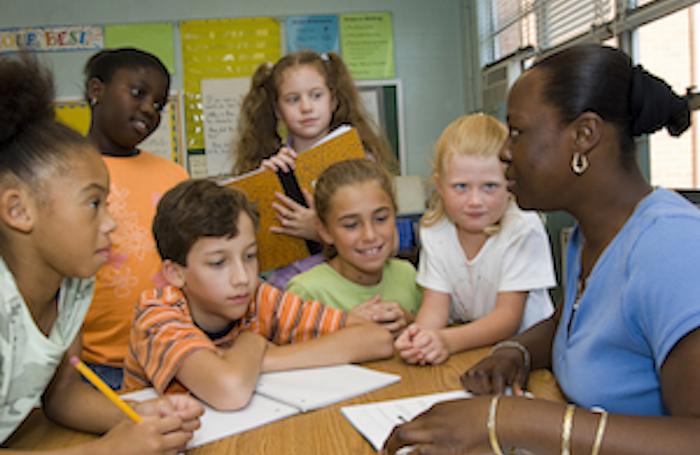 six engaged students listening intently to teacher