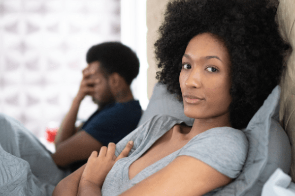 Couple upset, man in background with head in hand