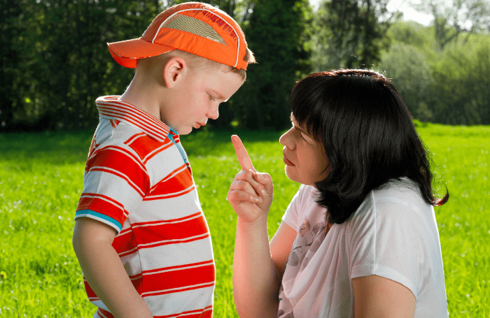 Mom disciplining son in the outdoors