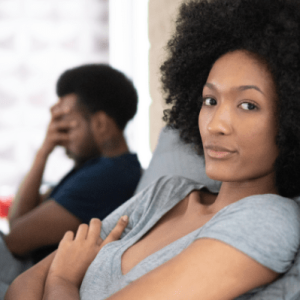 Couple upset, man in background with head in hand